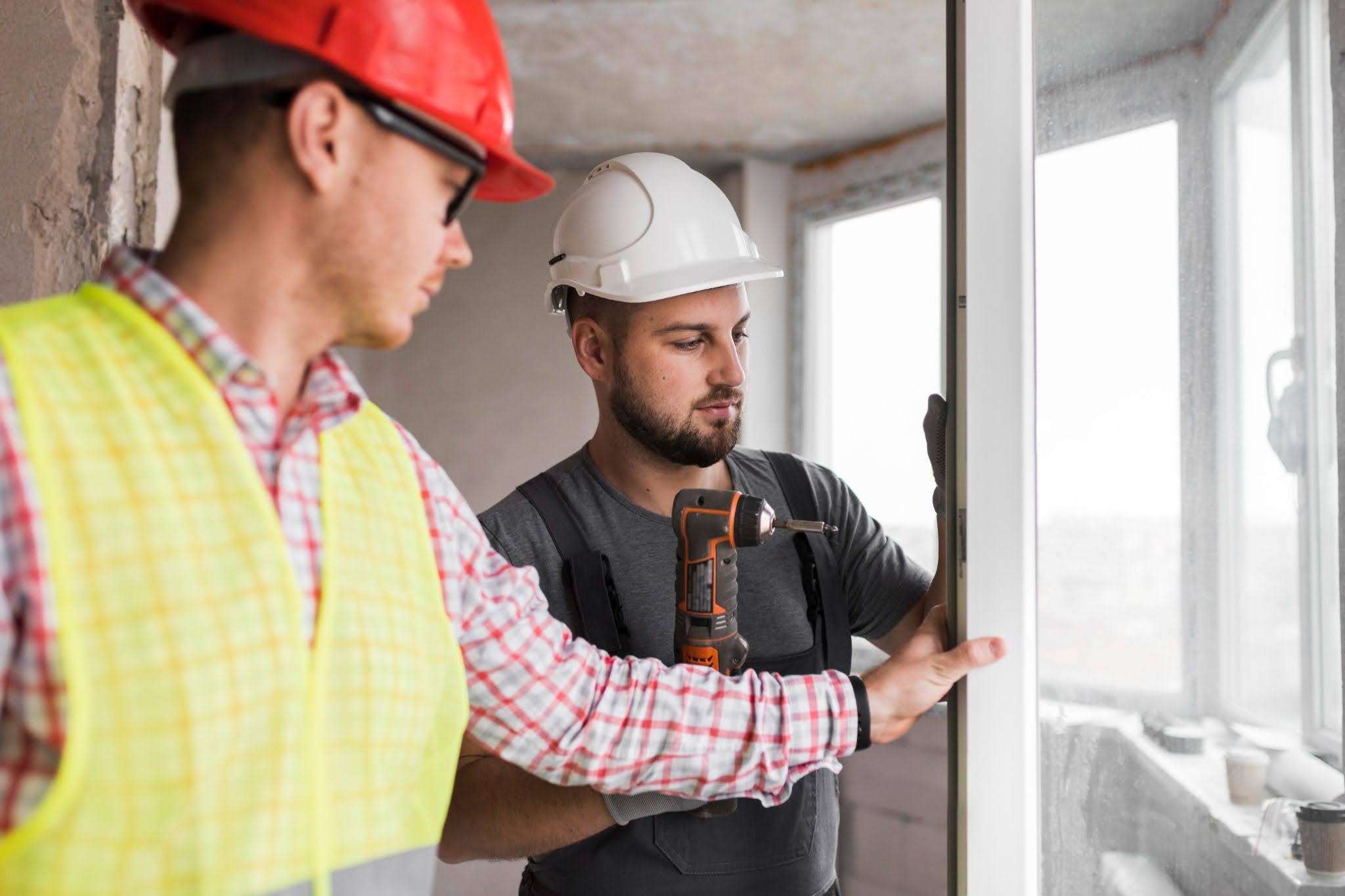 Two men installing impact windows. 